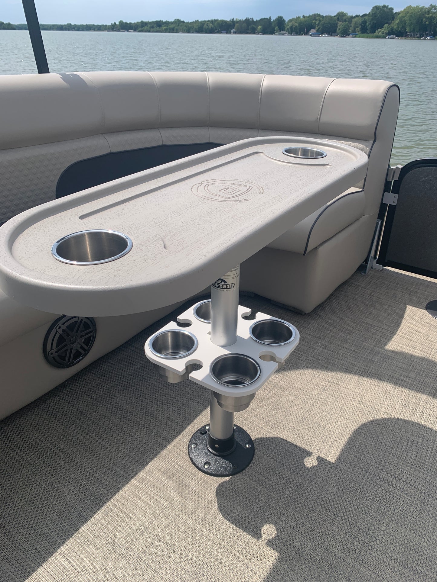 4 pc. Cup Holder on a Boat with water and trees in the background.