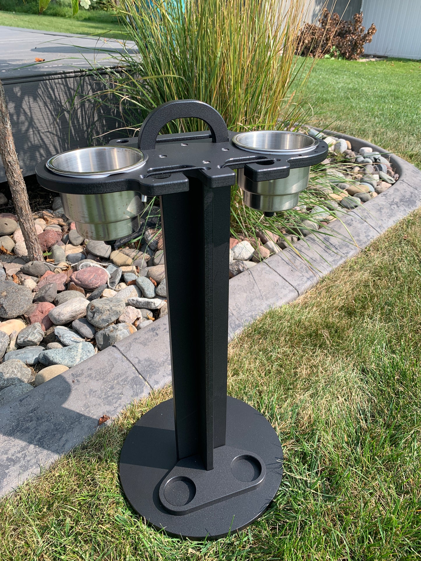 black colored 2 pc standing cup holder in a lawn