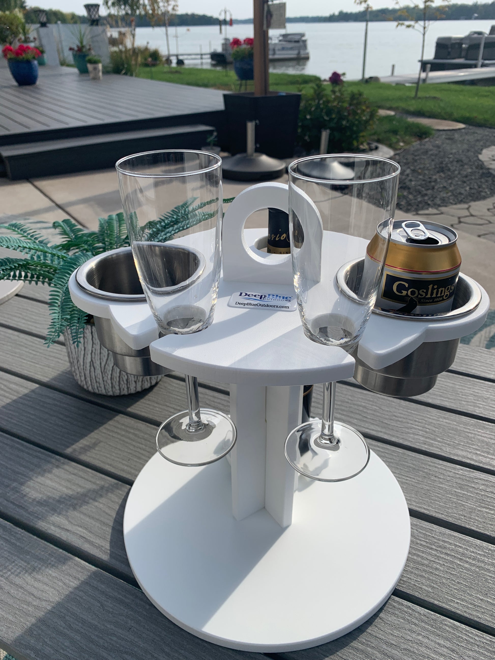 White Table Top Cup and Wine glass holder placed outdoors with soda cans